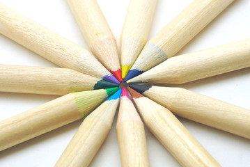 Group of mix pencil colors point sharp to center on white background.