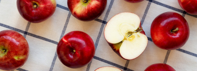 Fresh raw organic red apples on cloth, overhead view. Flat lay, from above, top view.