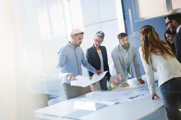 Team of architects working on construction plans