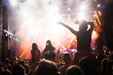 Fototapeta na wymiar Portrait of happy crowd enjoying at music festival