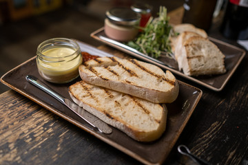 Chicken liver pate in jar and bread, selective focus