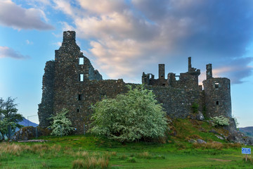 Fototapeta na wymiar Kilchurn Castle , in the care of Historic Environment Scotland , is a ruined structure on a rocky peninsula at Loch Awe in twilight , Argyll and Bute, Scotland