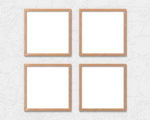 Fototapeta premium Set of 4 square wooden frames mockup hanging on the wall. Empty base for picture or text. 3D rendering.