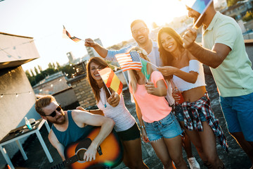 Group of happy friends having party on rooftop