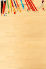 Obraz premium School various color stationery on the background of a light wooden table. Back to school concept, top view, copy space