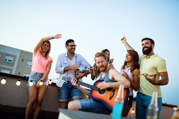 Group of carefree friends dancing have fun in summer