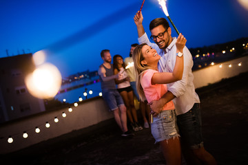 Happy young dancing couple having fun and enjoying party at summer