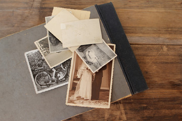 Retro some old photos and a photo album on an old natural wooden table