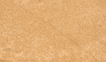 Fototapeta na wymiar Sand texture. Yellow-brown abstract background. Summer. Sunny day.