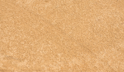 Fototapeta premium Sand texture. Yellow-brown abstract background. Summer. Sunny day.
