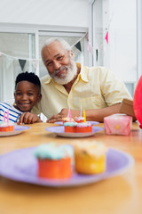Grandfather and grandson smiling