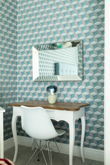 Table with chair and patterned wall