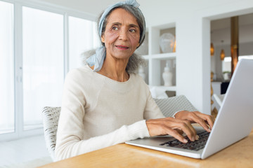 Woman using white laptop on a table.