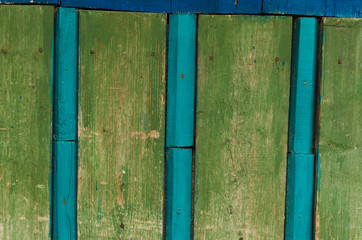 Wooden blue and green fence background closeup and boards