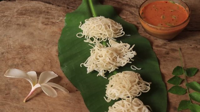 Breakfast dish with rice noodles known as Idiyappam or Idiyappam served with egg curry.