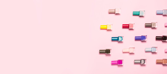 Colorful Nail polish bottles pattern background. Close up.