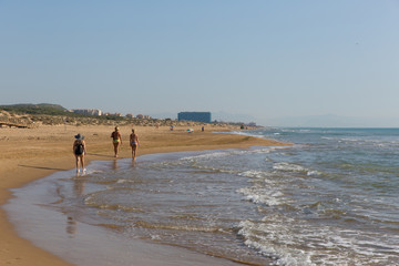 Fototapeta na wymiar People walking on beautiful natural beach between Torre La mata and Guardamar de Segura Costa Blanca Spain