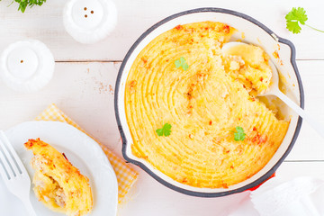 Potato casserole with meat stuffing in a frying pan, top view, horizontal