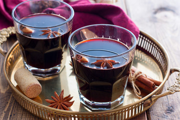 Mulled wine in glass cups on a beautiful tray, selective focus