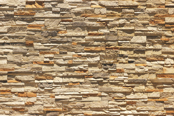 Brick wall of decorative slate stone, colorful horizontal architecture.Toned.