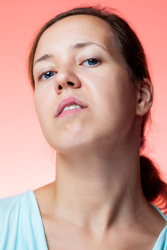 Portrait of an arrogant woman in the studio with isolated pink background