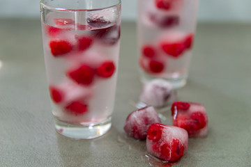 Summer raspberry drink with ice. Berry drink with fresh raspberries, ice lemonade in a glass.