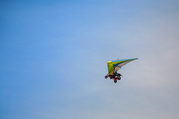 Fototapeta na wymiar Enjoy the extreme sense of freedom Flying on a motorized paraglide