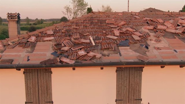 drone point of view inspecting dameged roof after storm