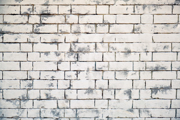 White brick wall texture. Background of brickwork painted in white with grey paint. Texture old bricks are painted.