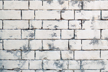 Fototapeta premium The background of masonry stones of different sizes painted in white. Texture retro bricks are painted. White brick wall, texture.