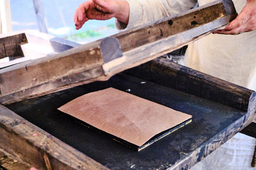 Printing book in a vintage way. Wooden retro typography mechanism for printing. Retro typographical press.