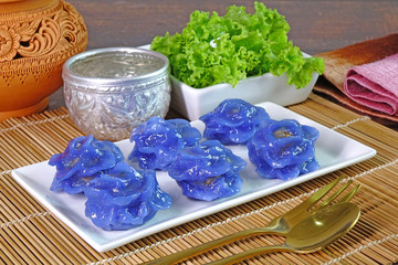 Royal Thai cuisine : Purple blue color Flower-shaped Thai dumpling (Khanom Chor Muang) Famous...