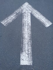 White Arrow.Forward signs on the road.Grey background