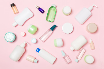 Group of plastic bodycare bottle Flat lay composition with cosmetic products on pink background empty space for you design. Set of White Cosmetic containers, top view with copy space