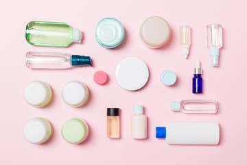 Group of plastic bodycare bottle Flat lay composition with cosmetic products on pink background empty space for you design. Set of White Cosmetic containers, top view with copy space