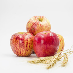 Arrangement with red apples and wheat ears