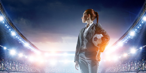 Business lady on football stadium. Mixed media