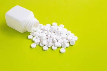 Tablets of Paracetamol on green background.
