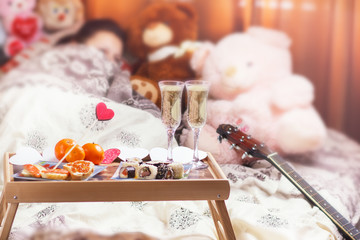 Healthy breakfast in bed with champagne. Valentine's Day romantic concept