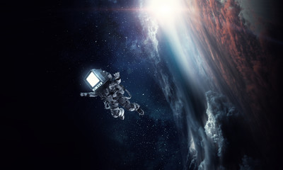 Obraz na płótnie Canvas Astronaut with TV head in space. Mixed media.