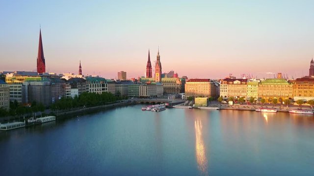 hamburg  aerial view at sunrise drone flying low over alster lake rising up over city skyline reveal shot