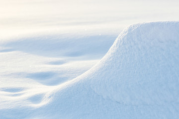 Fototapeta na wymiar snowdrift winter background with snow and blurred bokeh.