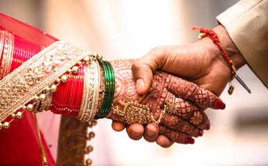 Indian Hindu Couple holding each other hands during their marriage symbolising love and affection....