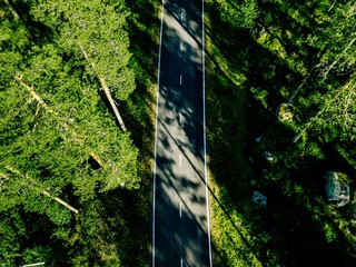 Aerial view of a road in green summer forest in Finland