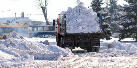 Snow-removal machine cleans the street of snow