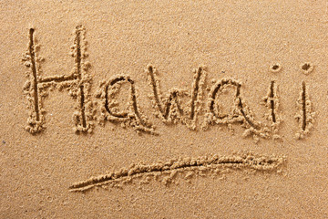 Hawaii word written in sand sign writing drawing drawn on a sunny hawaiian summer beach holiday vacation travel destination message photo