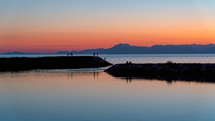 Fototapeta na wymiar Unidentified people silhouette at Side beach with mediterranean sea during sunset, Antalya, Turkey