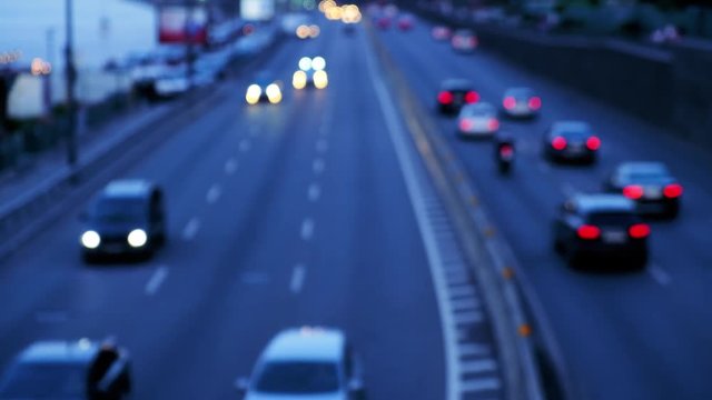Defocused night city car traffic lights. Color blurred bokeh of moving transport and typical city view