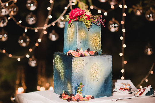 Stylish Modern Wedding Cake. Beautiful Dessert Decorated With Fresh Flowers, Fruits And Greenery.