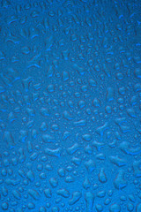 Liquid droplets detail on a blue background.